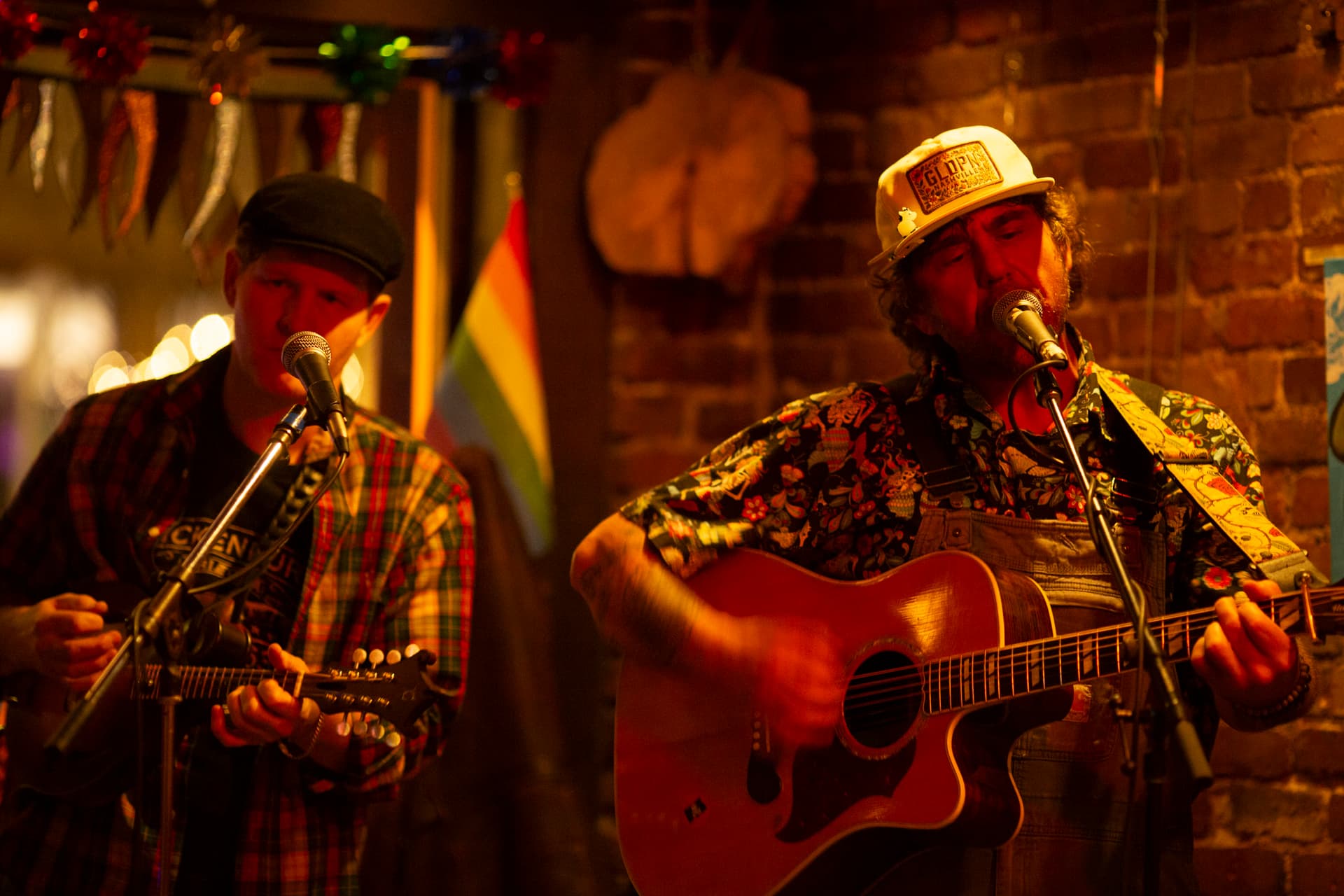 Ty Stonehawker performing live with his band against a brick wall