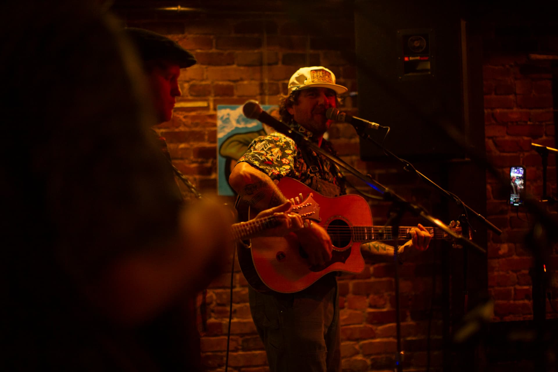 Ty Stonehawker mid-strum, dynamic live moment